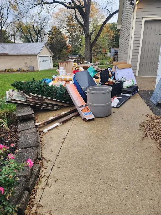 Dumpster being loaded with debris for 12 Yard Dumpster Rental in Youngtown